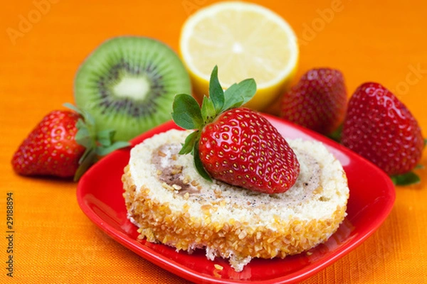 Fototapeta cake,kiwi,lemon and strawberries lying on the orange fabric