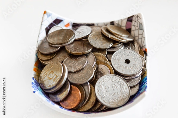 Obraz Collection of Ukrain, Switzerland and Norway coins in a bowl on white background