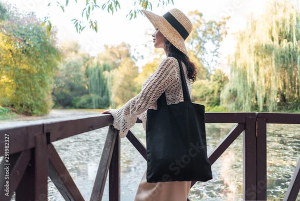 Obraz Woman with black blank bag outdoors in park. Place for Empty space. Copy space. Eco friendly.