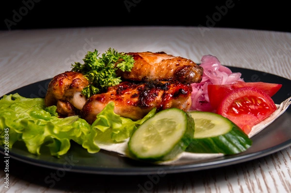 Obraz chicken wings with vegetables on a plate