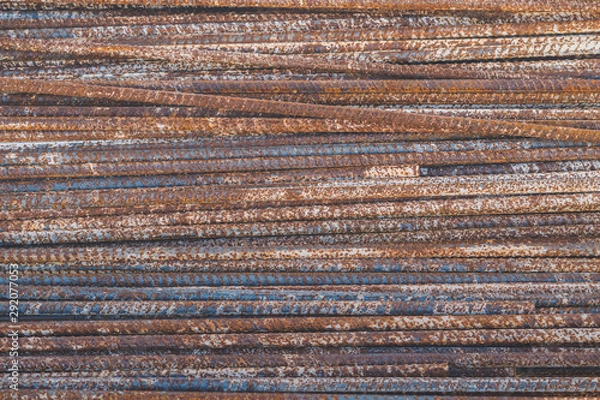 Fototapeta Background texture of old rusty steel bars construction materials in a construction site