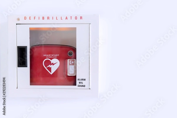 Fototapeta Automated External Defibrillator (AED) in white box on the wall Is an emergency pacemaker device for people with cardiac arrest. Heart defibrillator on white background.