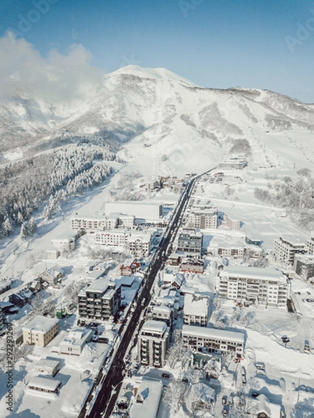 Obraz Winter in Niseko, Japan. A blue bird kind of day at Grand Hirafu, Niseko Ski Resort. Photos were taken with a drone overlooking the Grand Hirafu area with views of Mt. Niseko-Annupuri. and Mt. Yotei.