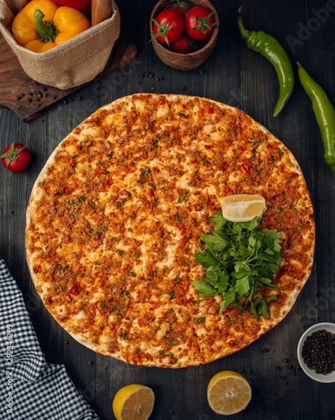 Fototapeta Lahmajun turkish pizza with minced meat, tomato, pepper, served with parslay, lemon