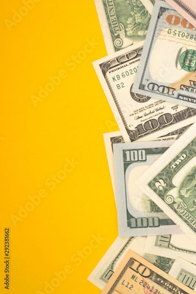 Fototapeta One hundred dollar banknotes on colored background top view, with empty place for your text business money concept.
