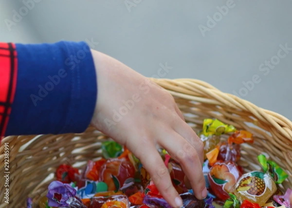 Obraz Hand taking candy from a basket