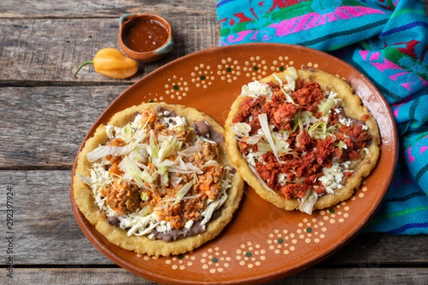 Fototapeta Mexican food: sopes of Chorizo and beef picadillo with cheese and beans