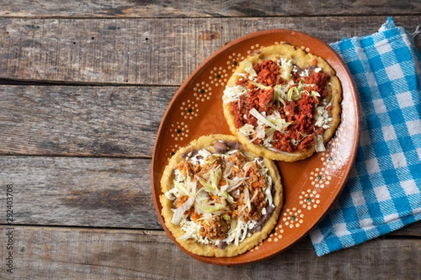 Fototapeta Mexican food: sopes of Chorizo and beef picadillo with cheese and beans