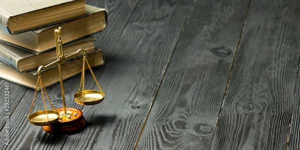 Fototapeta Law concept - Open law book with a wooden judges gavel on table in a courtroom or law enforcement office isolated on white background. Copy space for text.