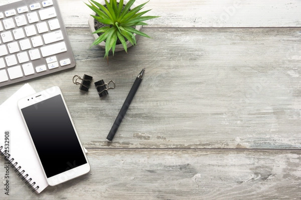Fototapeta White desk office with laptop, smartphone and other work supplies with cup of coffee. Top view with copy space for input the text. Designer workspace on desk table essential elements on flat lay