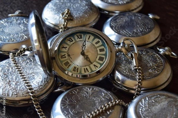 Fototapeta Vintage pocket watch with a red dial in retro style close up. Selective focus. Photo background