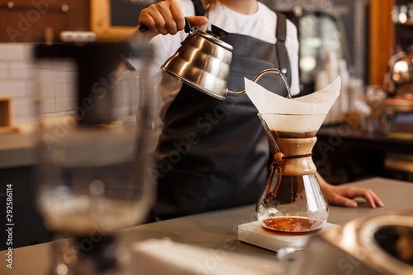 Obraz Profesjonalny barista przygotowujący kawę za pomocą chemexu zalać ekspresem i czajnikiem kroplowym. Młoda kobieta parzenia kawy. Alternatywne sposoby parzenia kawy. Koncepcja kawiarni.