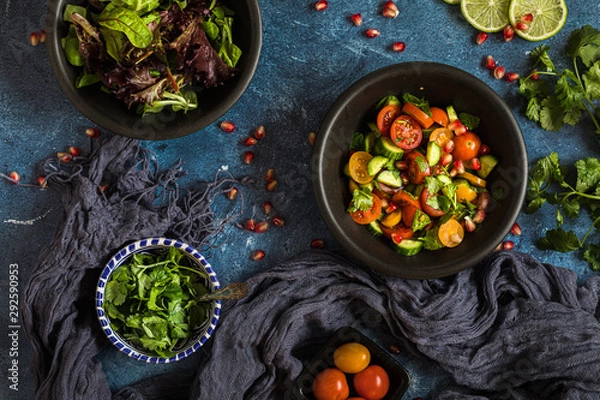 Obraz Fresh salad with tomato, cucumber and herbs, flat lay from above