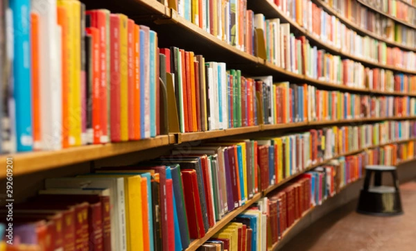 Fototapeta Library with many shelves and books, diminishing perspective and shallow dof