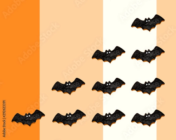 Fototapeta オレンジとベージュと白の3色バックにコウモリを並べてコピースペース