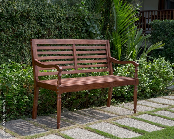 Fototapeta The wood bench in the garden.