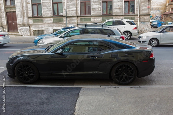 Obraz Cars move along a narrow street