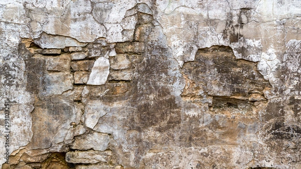 Fototapeta background of a damaged stone wall