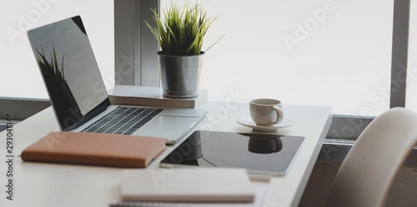 Fototapeta Comfortable home-office corner with laptop computer, tablet and office supplies with coffee cup