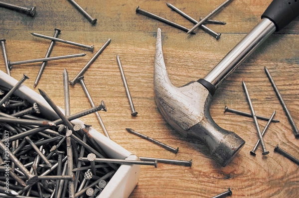Obraz Hammer and a bunch of construction nails closeup. Repair concept.