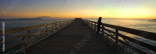 Obraz woman on a pier during sunset