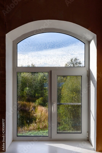 Fototapeta Raindrops on the window. The concept of rainy weather. The texture of the rain.