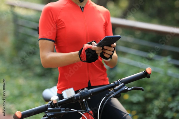 Fototapeta Riding on bike path,using smartphone while riding bike on sunny day