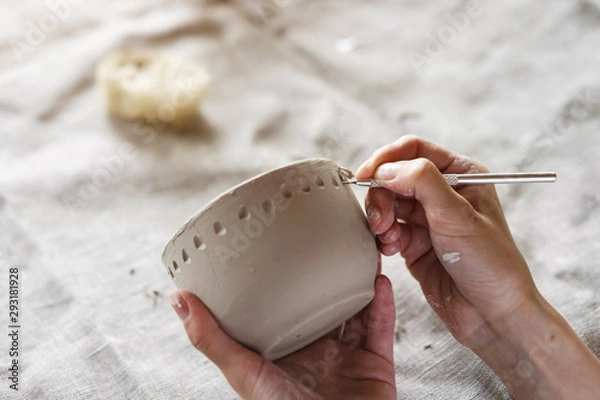 Fototapeta Female hands hold a bowl for casting clay products. Shaped method for making clay dishes. Handwork. Pottery making