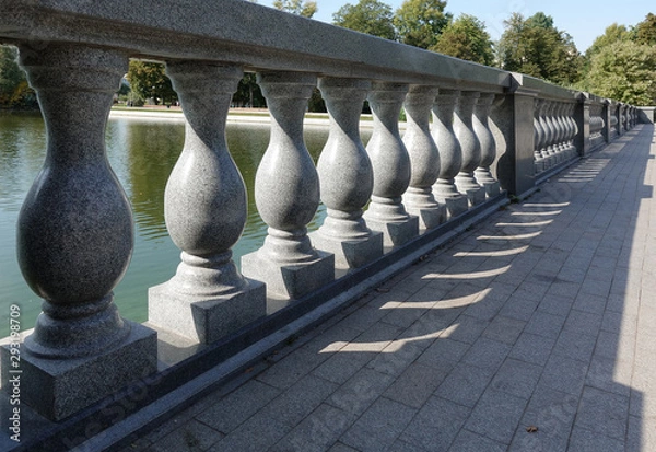 Fototapeta Concrete balustrade with classical pillars standing in a row. Beautiful detail of an old fence