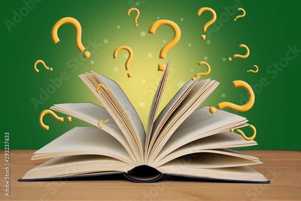 Fototapeta open paper book with magic glow and question marks, concept of magic and mystery, on a wooden table, horizontal, close-up, copy space