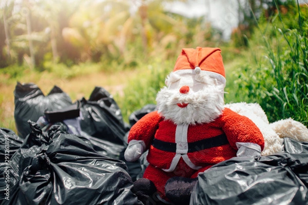 Fototapeta Santa Claus doll is dumped in a dump. garbage.