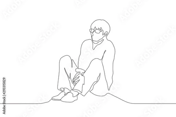 Fototapeta A continuous line of art man with glasses sits alone on the floor, clenching his shoulders and holding his hands together between his legs. The concept of loneliness. Can be used for animation