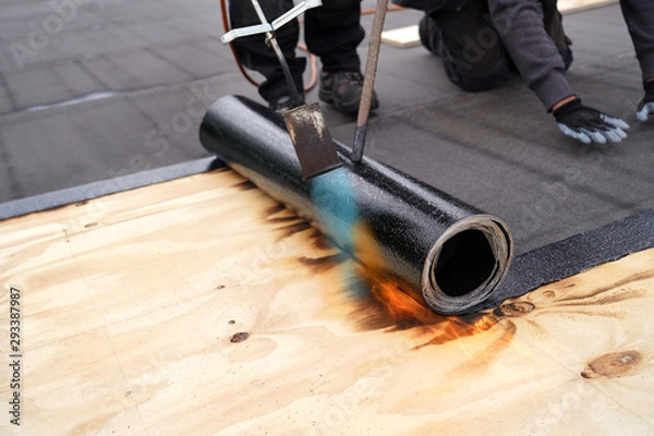 Obraz Bitumen roofing.,  with a gas burner and a roll of tar paper. Flat roof installation.