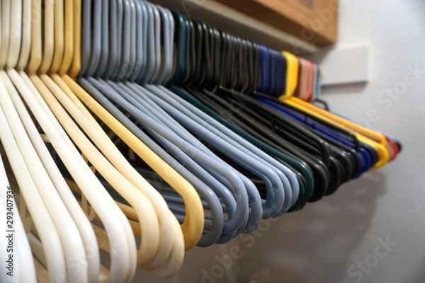 Obraz Plastic hangers in empty closet