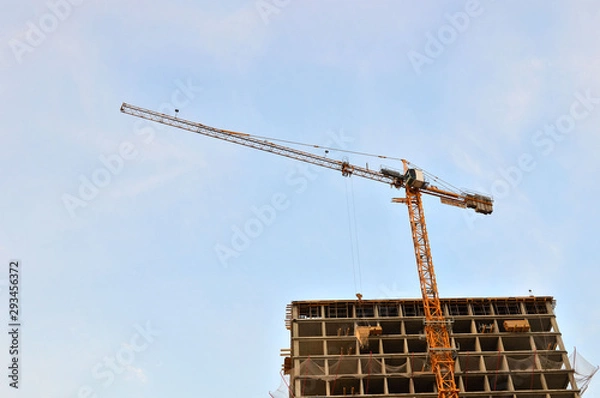 Fototapeta Tower cranes at construction site, construction of high-rise building  - Image
