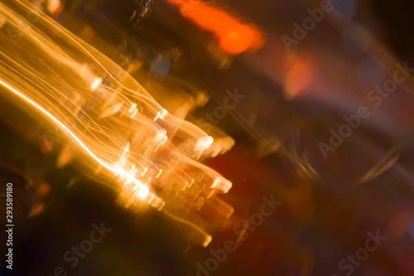 Obraz Defocused abstract background image. Drawing with light at low shutter speed. The effect of a shooting star on an abstract background. The state of intoxication expressed in the photo.
