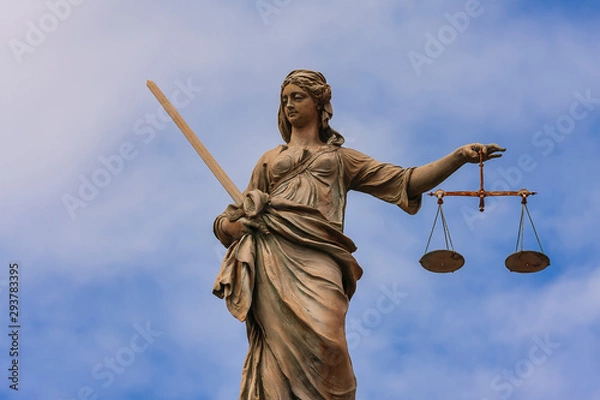Obraz Statue of Lady Justice at Dublin Castle in Dublin, Ireland,Stature of lady with sword holding scales of justice on top of Dublin Castle buildings.