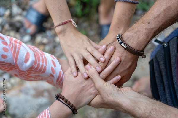 Fototapeta Many hands getting together in the center of a circle. Close up outdoor shot