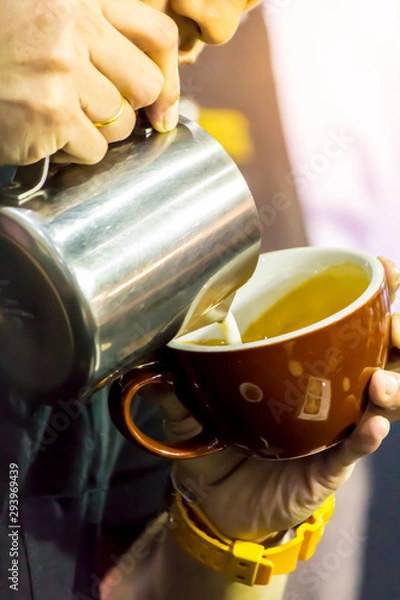 Fototapeta Showcase Barista making Latte art coffee and Barista heating milk for making Latte art coffee.