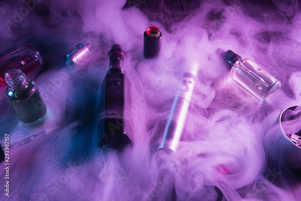 Fototapeta vaping device mod and vaping staff on dark background