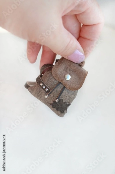 Obraz  Miniature leather backpack. Small backpack on a palm