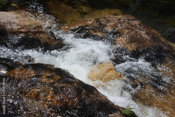 Obraz water flowing over rocks
