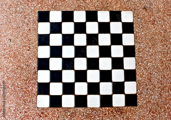 Fototapeta The stone table has a white and black checkerboard.