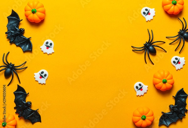 Fototapeta Halloween holiday concept, Pumpkin, bats, white skeleton and tiny ghost in orange background with copy space for text, Top flat view wallpaper