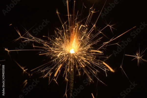 Fototapeta sparks on black background close up