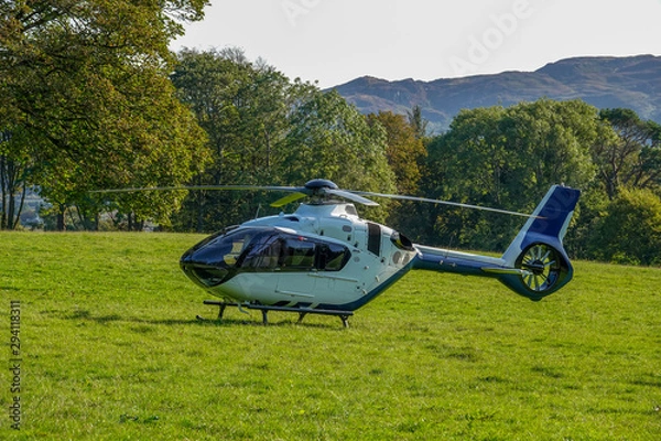 Fototapeta Helicopter landed in the middle of a field