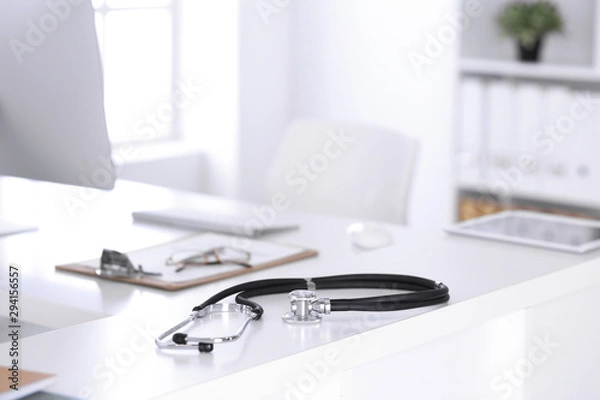 Fototapeta Stethoscope, prescription medical form lying on a table with pc computer. Medicine or pharmacy concept. Medical tools at doctor working table