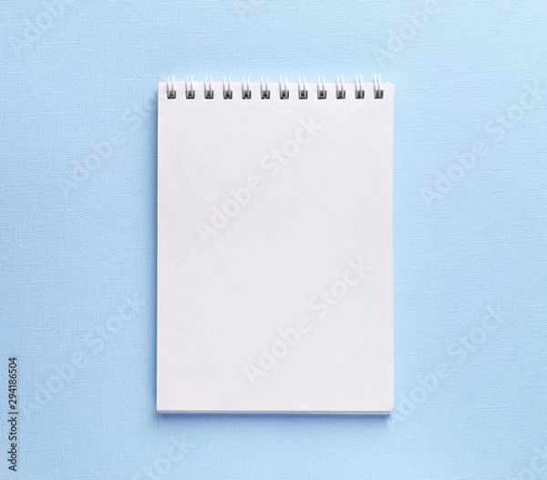 Fototapeta open notebook on light blue background