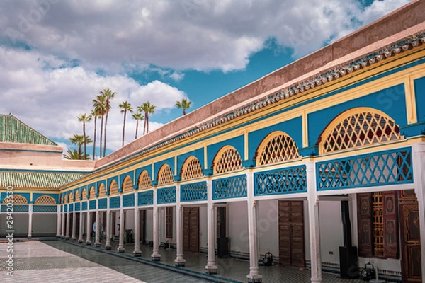 Obraz Landscape view of the centre area of the palace, built in traditional form with many decorations. Sky and palm trees in the background Marrakech, Morocco.