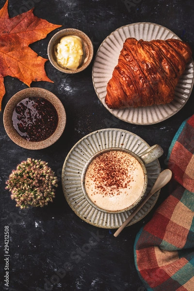Fototapeta cappuccino coffee with croissant on the table, autumn breakfast concept, top view